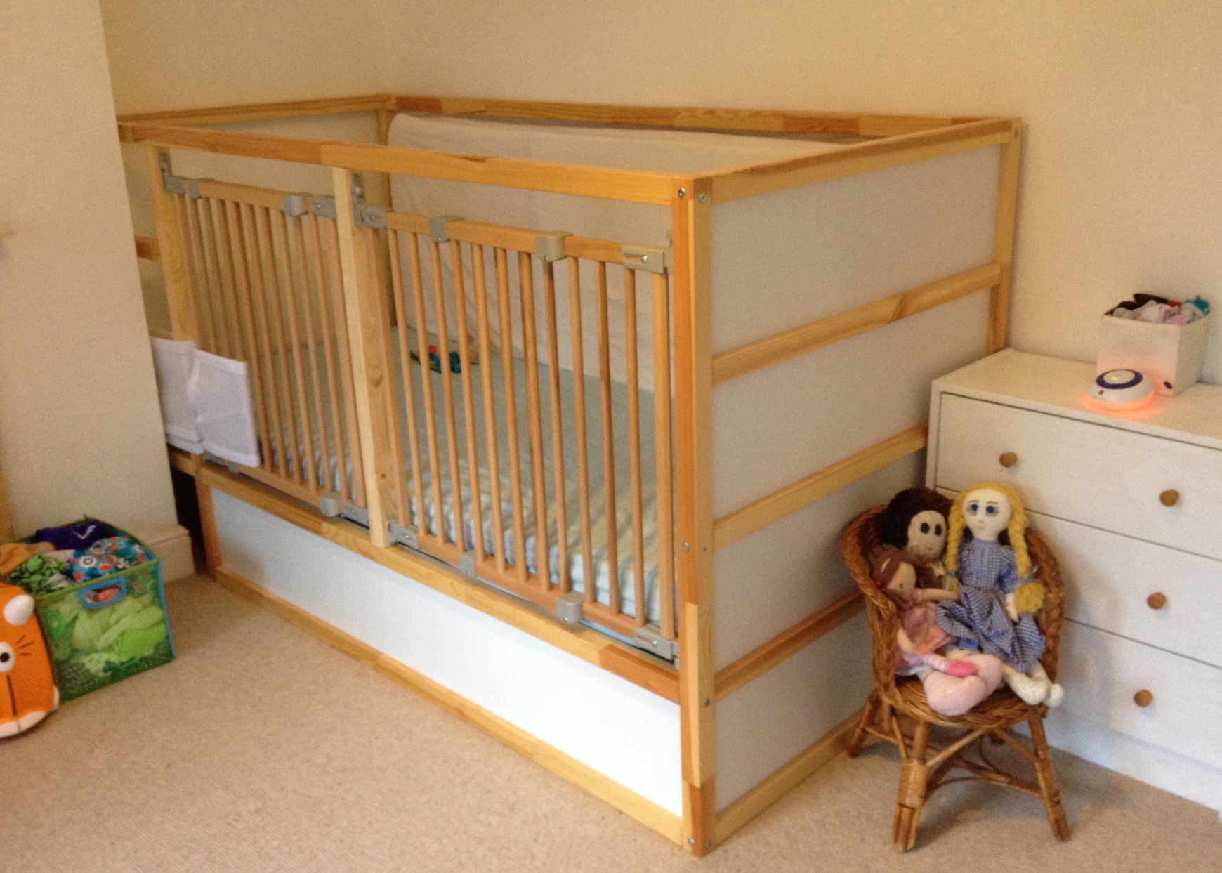 View of our original hack of an Ikea Kura bed with wooden stair gates infilling the open side