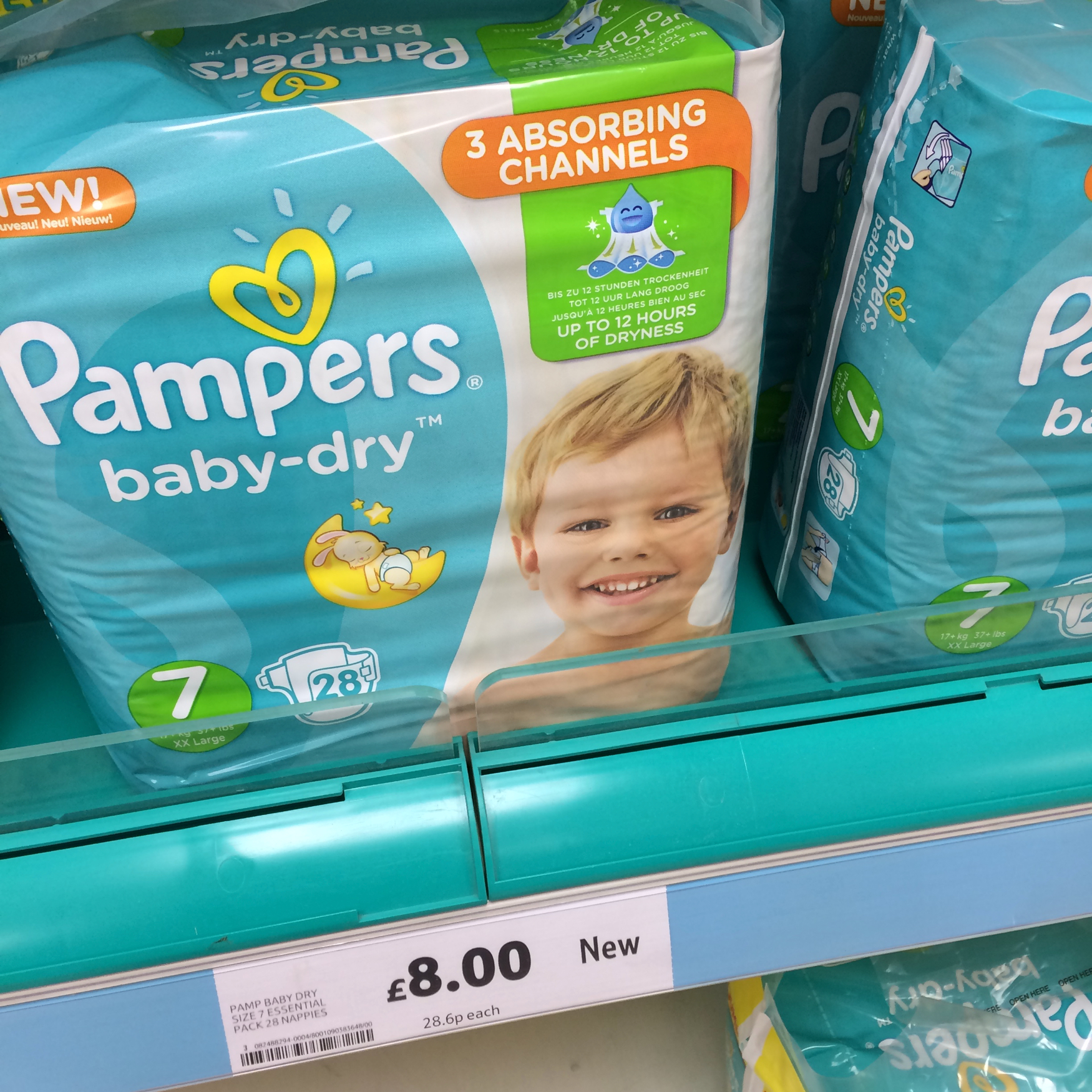Pampers new size 7 nappies on a shelf in Tesco